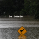 Ducks swim next to a submerged sign in floodwaters in Richmond suburb on March 22, 2021, as Sydney braced for its worst flooding in decades after record rainfall caused its largest dam to overflow and as deluges prompted mandatory mass evacuation orders along Australia’s east coast.